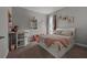 Cozy bedroom featuring a full bed, a changing table, and soft lighting for a warm, inviting space at 11713 Goldenrod Ave, Bradenton, FL 34212