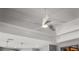 A modern white ceiling fan with unique blade design complements the tray ceiling at 11713 Goldenrod Ave, Bradenton, FL 34212