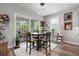 Cozy dining area adjacent to the kitchen with modern lighting and access to outdoor patio at 11713 Goldenrod Ave, Bradenton, FL 34212