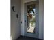 Elegant front door adorned with a wreath, complemented by tasteful wall decor and modern security features at 11713 Goldenrod Ave, Bradenton, FL 34212
