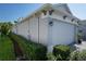 The side of a home with a three-car garage, tidy landscaping and lawn at 11713 Goldenrod Ave, Bradenton, FL 34212