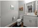 Neutral half bath offering a framed mirror, framed art and stylish vanity with plenty of room at 11713 Goldenrod Ave, Bradenton, FL 34212