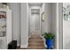 Well-lit hallway with hardwood floors and a view of the bedroom at the end of the hall at 11713 Goldenrod Ave, Bradenton, FL 34212