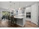 Bright kitchen with white cabinets, island seating, stainless steel appliances, and pendant lighting at 11713 Goldenrod Ave, Bradenton, FL 34212