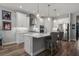 Clean kitchen featuring an island with counter seating, stainless steel appliances, and modern lighting at 11713 Goldenrod Ave, Bradenton, FL 34212