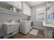 Functional laundry room with washer, dryer, sink, and storage cabinets at 11713 Goldenrod Ave, Bradenton, FL 34212