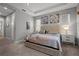 Bright main bedroom with floral artwork, and ceiling fan, featuring bedside tables and lamps at 11713 Goldenrod Ave, Bradenton, FL 34212