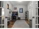 Office with french doors, desk, bookshelves, and neutral decor, perfect for a productive work environment at 11713 Goldenrod Ave, Bradenton, FL 34212