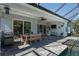 A screened lanai features a dining area, lounge space, and outdoor kitchen with serene pool views at 11713 Goldenrod Ave, Bradenton, FL 34212