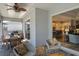 The covered patio has an outdoor dining area, seating, and access to the kitchen through sliding glass doors at 11713 Goldenrod Ave, Bradenton, FL 34212