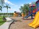 A vibrant playground overlooking a lake featuring multiple slides and play areas, perfect for active recreation in a scenic setting at 11713 Goldenrod Ave, Bradenton, FL 34212
