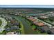 Gorgeous aerial view of community with lake running through it and lush green landscaping at 12012 Legacy Estates Blvd, Sarasota, FL 34238