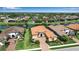 Attractive home with a tile roof situated along a peaceful lake at 12012 Legacy Estates Blvd, Sarasota, FL 34238