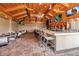Outdoor bar area with multiple televisions, a long bar, and a decorated wood ceiling at 12012 Legacy Estates Blvd, Sarasota, FL 34238