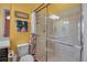 Bathroom showcasing a glass-enclosed shower, toilet, vanity, and patterned shower curtain at 12012 Legacy Estates Blvd, Sarasota, FL 34238
