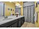 Elegant bathroom with a double sink vanity, decorative mirror, and neutral tile flooring at 12012 Legacy Estates Blvd, Sarasota, FL 34238