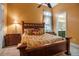 Comfortable bedroom showcasing a decorative wooden bed frame and a glimpse of the adjoining bathroom at 12012 Legacy Estates Blvd, Sarasota, FL 34238