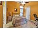 Bedroom with ceiling fan and yellow walls, featuring a comfortable bed and bedside tables at 12012 Legacy Estates Blvd, Sarasota, FL 34238