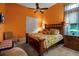 Cozy bedroom with wooden bed frame, floral bedding, and plenty of natural light at 12012 Legacy Estates Blvd, Sarasota, FL 34238