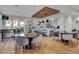 Inviting common area featuring modern tables, chairs, kitchen with bar seating, and a warm, neutral color palette at 12012 Legacy Estates Blvd, Sarasota, FL 34238
