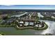 Aerial view of community pool area with lush landscape, playground, clubhouse, and tennis courts at 12012 Legacy Estates Blvd, Sarasota, FL 34238