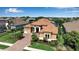 Inviting home with a well-maintained lawn, mature palms, and a tile roof at 12012 Legacy Estates Blvd, Sarasota, FL 34238