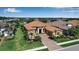 Stunning home featuring a tile roof, manicured landscaping, and a welcoming brick driveway at 12012 Legacy Estates Blvd, Sarasota, FL 34238