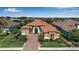Beautiful single-story home boasts lush landscaping, a tile roof, and a charming entrance at 12012 Legacy Estates Blvd, Sarasota, FL 34238