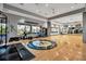 Bright, well-equipped gym featuring hardwood floors, exercise equipment, and views of the outdoors at 12012 Legacy Estates Blvd, Sarasota, FL 34238