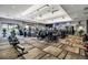 Spacious gym featuring modern exercise equipment, wall-mounted TVs, and a neutral color scheme at 12012 Legacy Estates Blvd, Sarasota, FL 34238