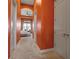 Hallway leading to an inviting bedroom with large windows and a seating area at 12012 Legacy Estates Blvd, Sarasota, FL 34238