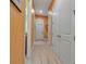 Hallway featuring clean white doors, neutral flooring, and bright orange walls leading to various rooms at 12012 Legacy Estates Blvd, Sarasota, FL 34238