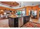 The spacious kitchen island overlooks the dining and living rooms with stainless appliances and modern hanging lights at 12012 Legacy Estates Blvd, Sarasota, FL 34238