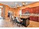 Bright kitchen boasts a large island with seating, wooden cabinets, stainless appliances, and modern pendant lighting at 12012 Legacy Estates Blvd, Sarasota, FL 34238
