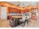 Spacious kitchen features wooden cabinets, stainless steel appliances, and a large center island with seating at 12012 Legacy Estates Blvd, Sarasota, FL 34238