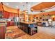 Open-concept kitchen features a large island, wooden cabinets, stainless steel appliances, and flows into the living area at 12012 Legacy Estates Blvd, Sarasota, FL 34238