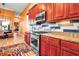 Gourmet kitchen showcases wooden cabinets, stainless steel appliances, granite countertops, and subway tile backsplash at 12012 Legacy Estates Blvd, Sarasota, FL 34238