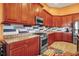 Well-equipped kitchen boasts wooden cabinets, stainless steel appliances, granite countertops, and stylish backsplash at 12012 Legacy Estates Blvd, Sarasota, FL 34238
