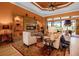 Cozy living room with a tiled fireplace, shelves, comfortable seating, and natural light at 12012 Legacy Estates Blvd, Sarasota, FL 34238