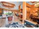 Open living room featuring wood-look tile flooring, orange walls, and modern decor at 12012 Legacy Estates Blvd, Sarasota, FL 34238
