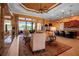 Spacious living room featuring wood-look tile flooring, orange walls, and an open floor plan at 12012 Legacy Estates Blvd, Sarasota, FL 34238