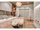 Bright massage room with hardwood floors, stone accent wall, modern lighting, sink, and stylish furnishings at 12012 Legacy Estates Blvd, Sarasota, FL 34238
