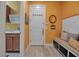 Functional mudroom with built-in seating, storage hooks, and a convenient laundry sink area at 12012 Legacy Estates Blvd, Sarasota, FL 34238