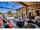 Relaxing screened patio with comfortable seating and beautiful views of the pool and surrounding landscape at 12012 Legacy Estates Blvd, Sarasota, FL 34238
