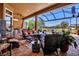Spacious screened patio with comfortable seating, outdoor kitchen, and serene water views at 12012 Legacy Estates Blvd, Sarasota, FL 34238