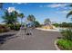 Community playground with play structure and splash pad surrounded by trees and blue sky at 12012 Legacy Estates Blvd, Sarasota, FL 34238