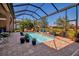 Beautiful pool with screen enclosure offers lovely landscaping and peaceful water views at 12012 Legacy Estates Blvd, Sarasota, FL 34238