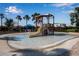 Community splash pad with slide and water features, surrounded by palm trees and landscaping at 12012 Legacy Estates Blvd, Sarasota, FL 34238