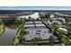 Aerial view of the community tennis and pickleball courts adjacent to the lake and clubhouse at 12012 Legacy Estates Blvd, Sarasota, FL 34238
