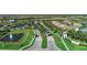 Breathtaking aerial view of a community featuring tree-lined streets, lush landscaping, and serene ponds at 12291 Myrtle Bay Ct, Sarasota, FL 34238
